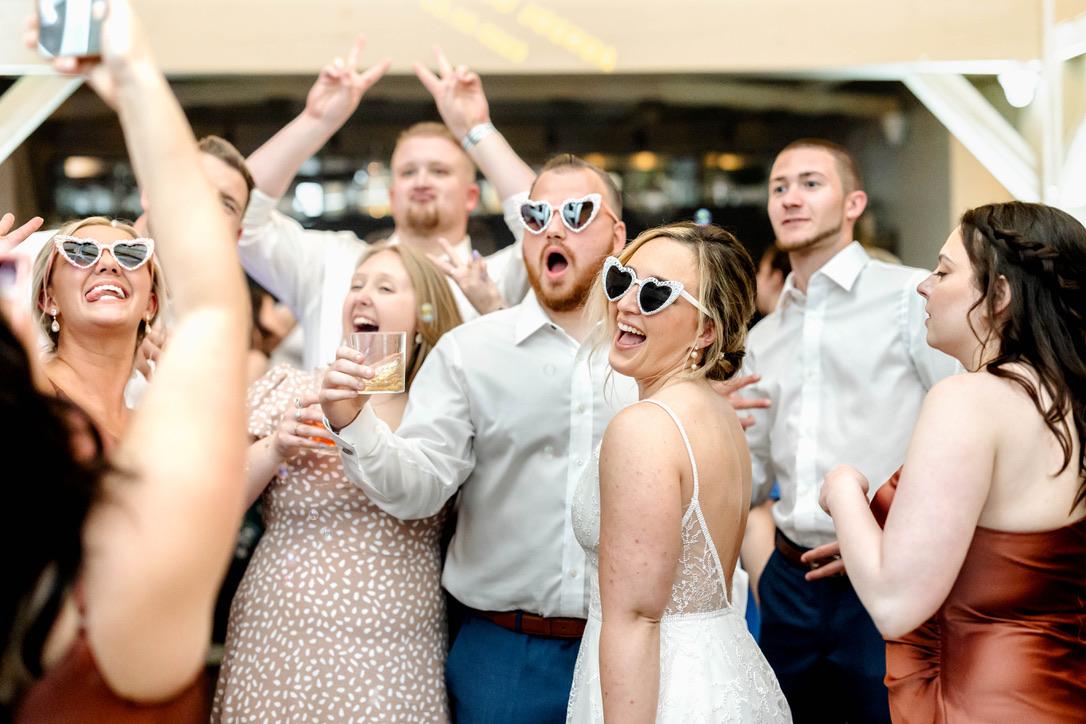 wedding guest laughing in sunglasses
