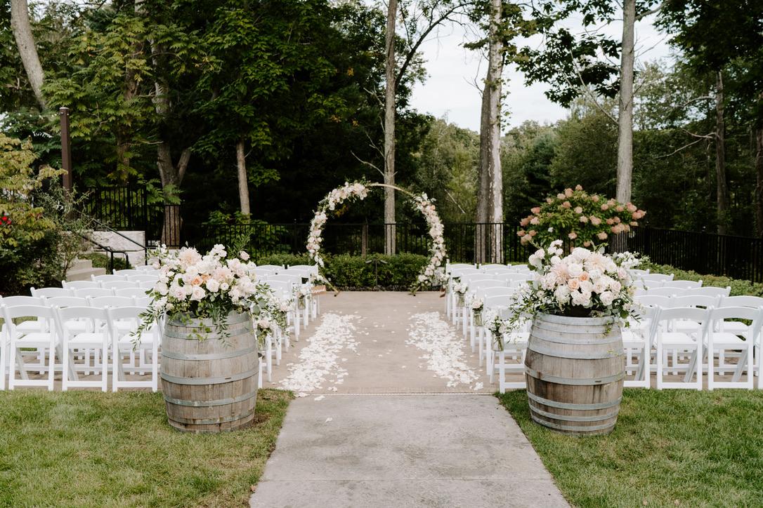 outdoor wedding ceremony with round floral arch