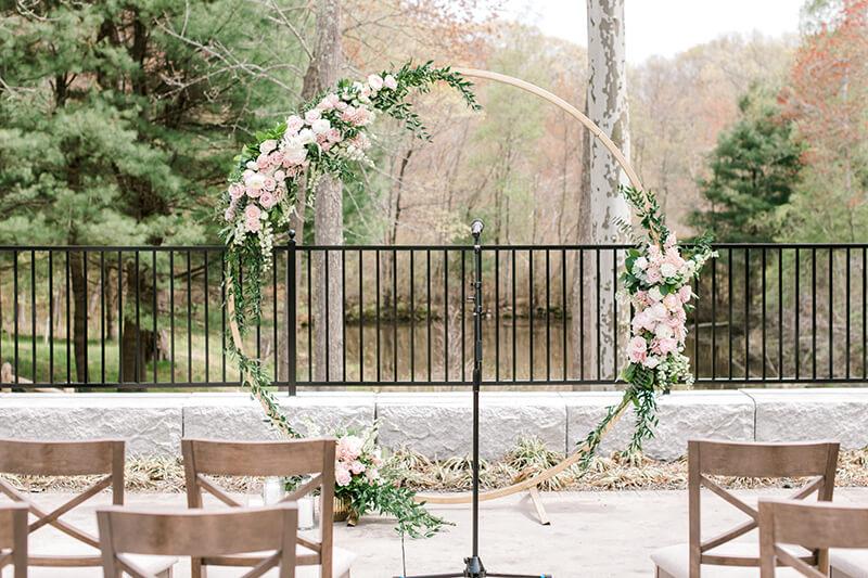 Gold arbor with floral decorations at ceremony