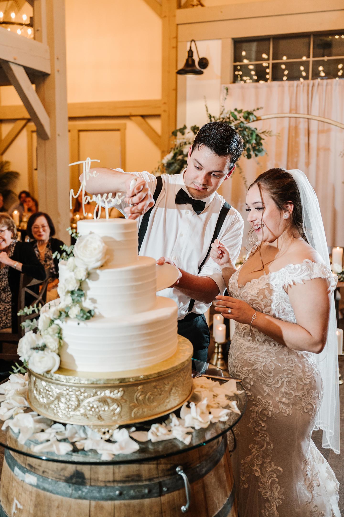 Couple cutting floral wedding cake