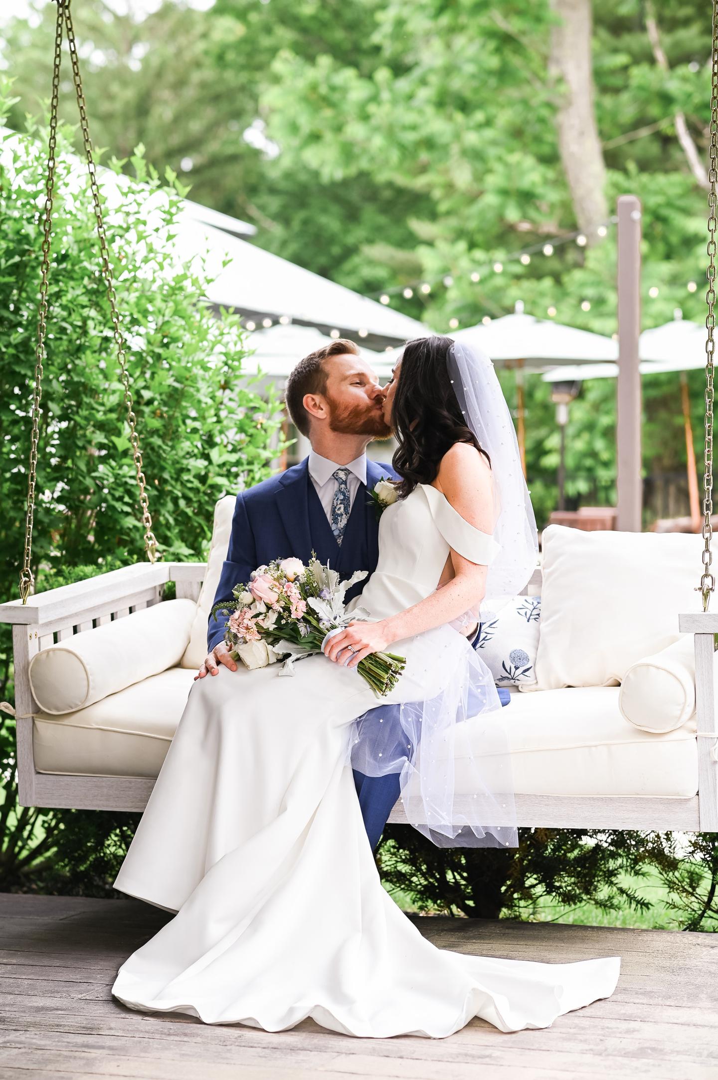 bride and groom on porch swing at wedding