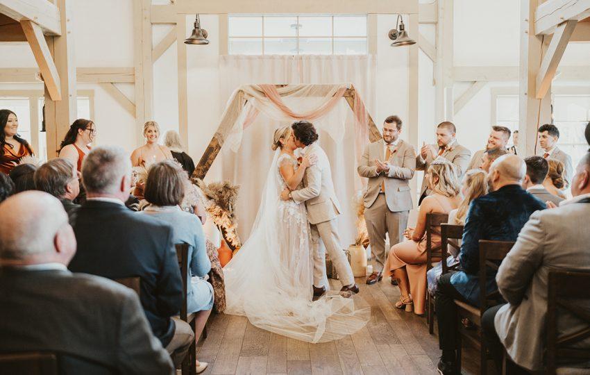 Bride and groom kiss and wedding ceremony