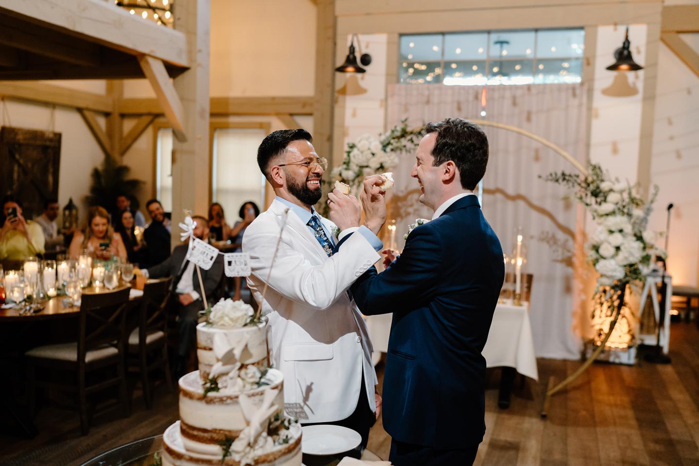 groom and groom during cake cutting