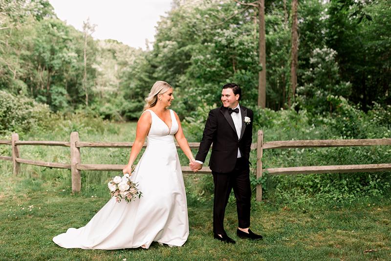 Bride and groom walking in forest