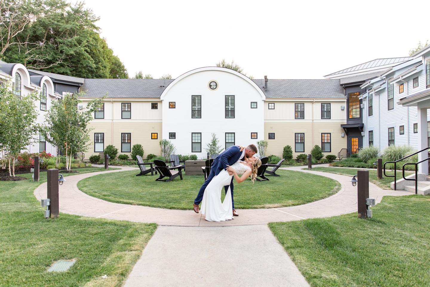 bride and groom kiss in courtyard