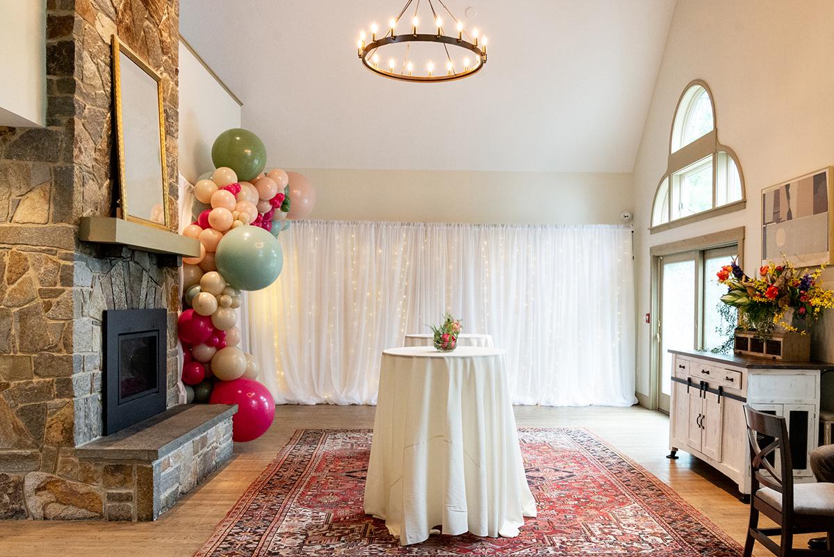 Event space with central table and balloon arch