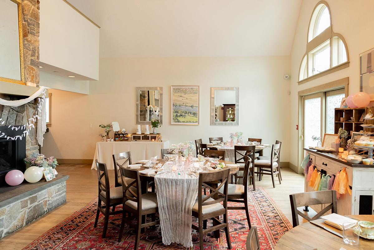 Small decorated event space with tables and chairs