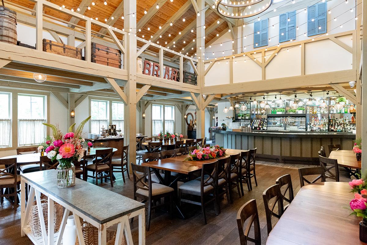 Large event space with high ceilings, and tables and chairs