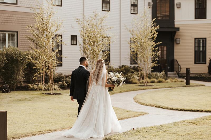 Bride and groom walking through courtyard