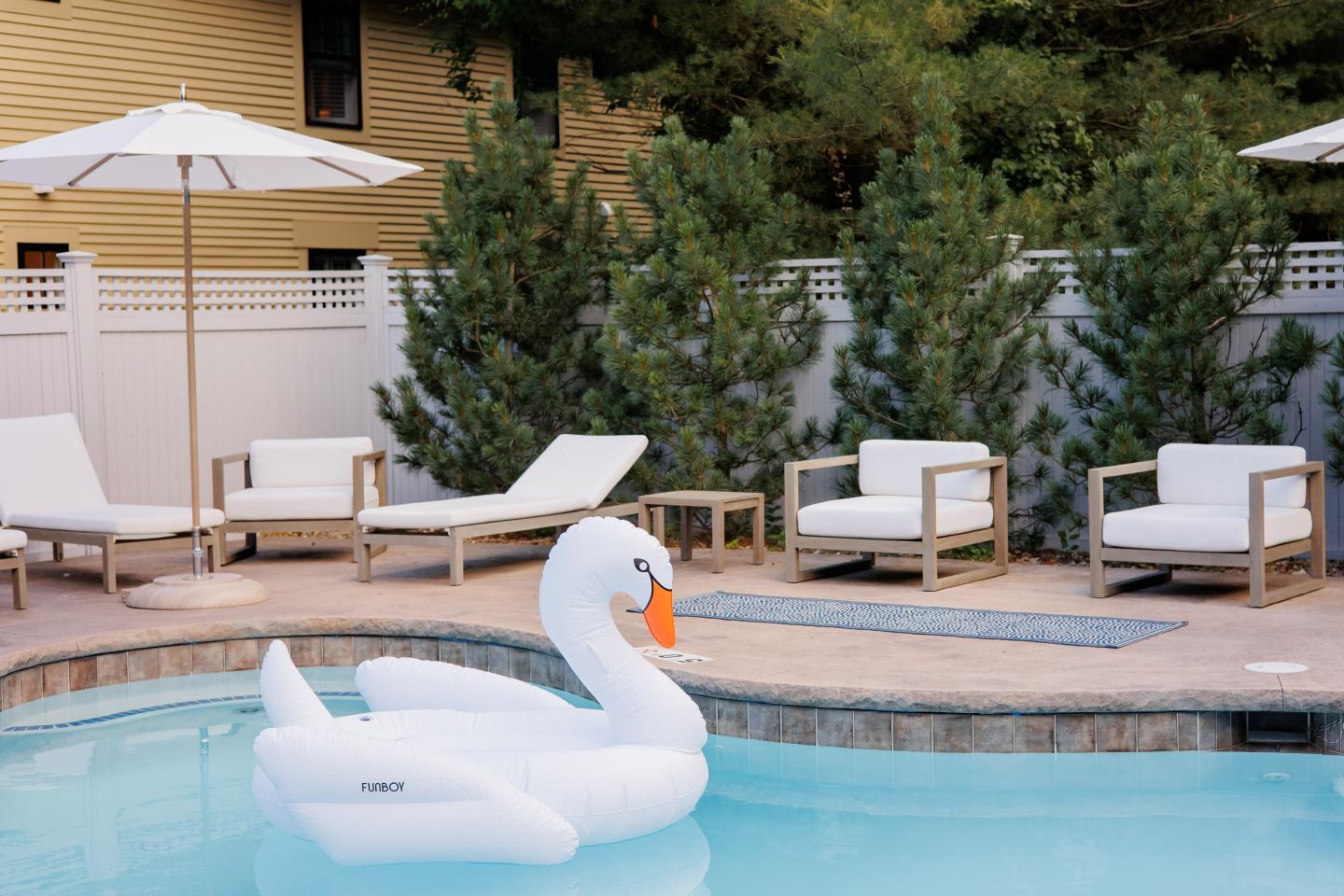 An outdoor pool with an inflatable swan