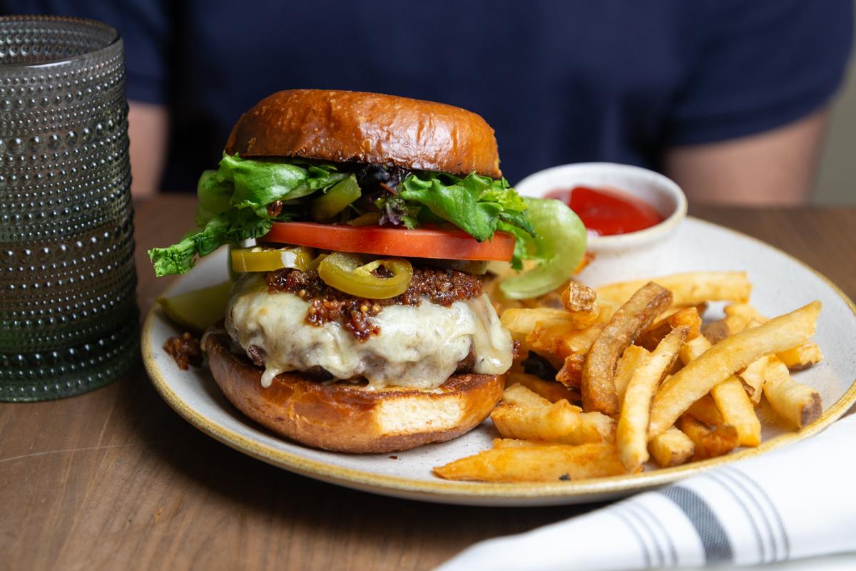 signature burger with pickled jalepenos, bacon jam, and house cut fries