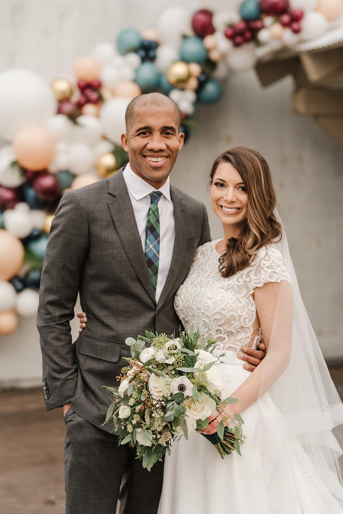couple with balloon garland