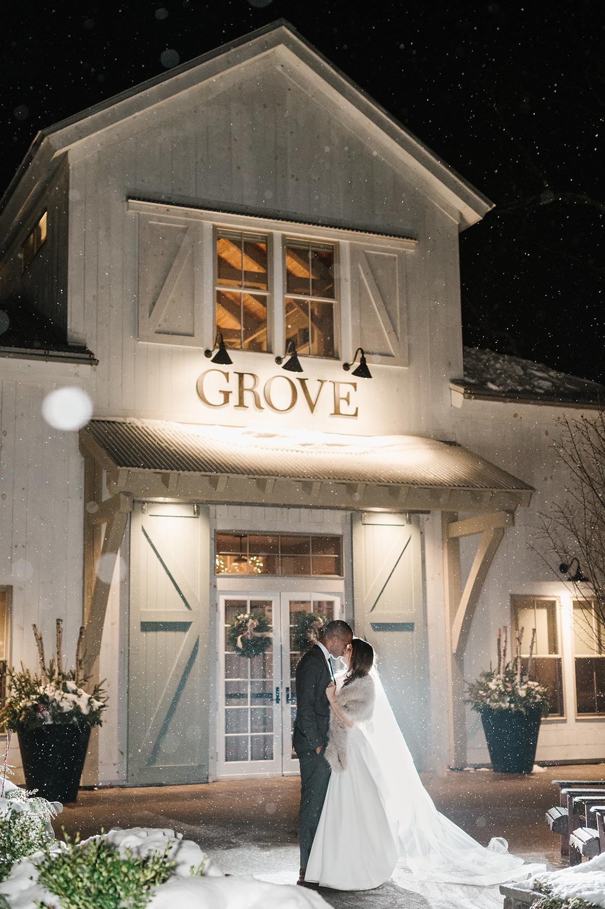 couple in front of grove at night