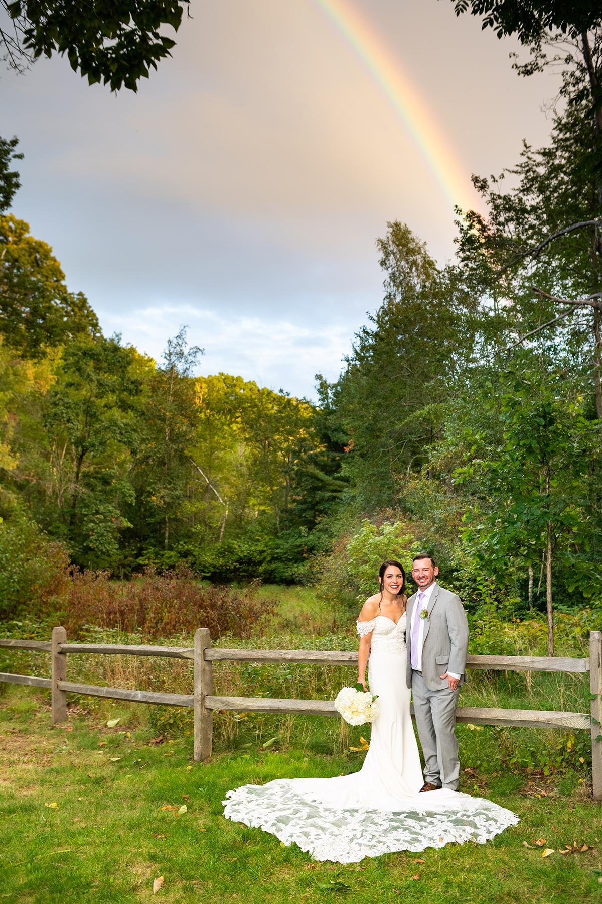 bride and groom with rainbow