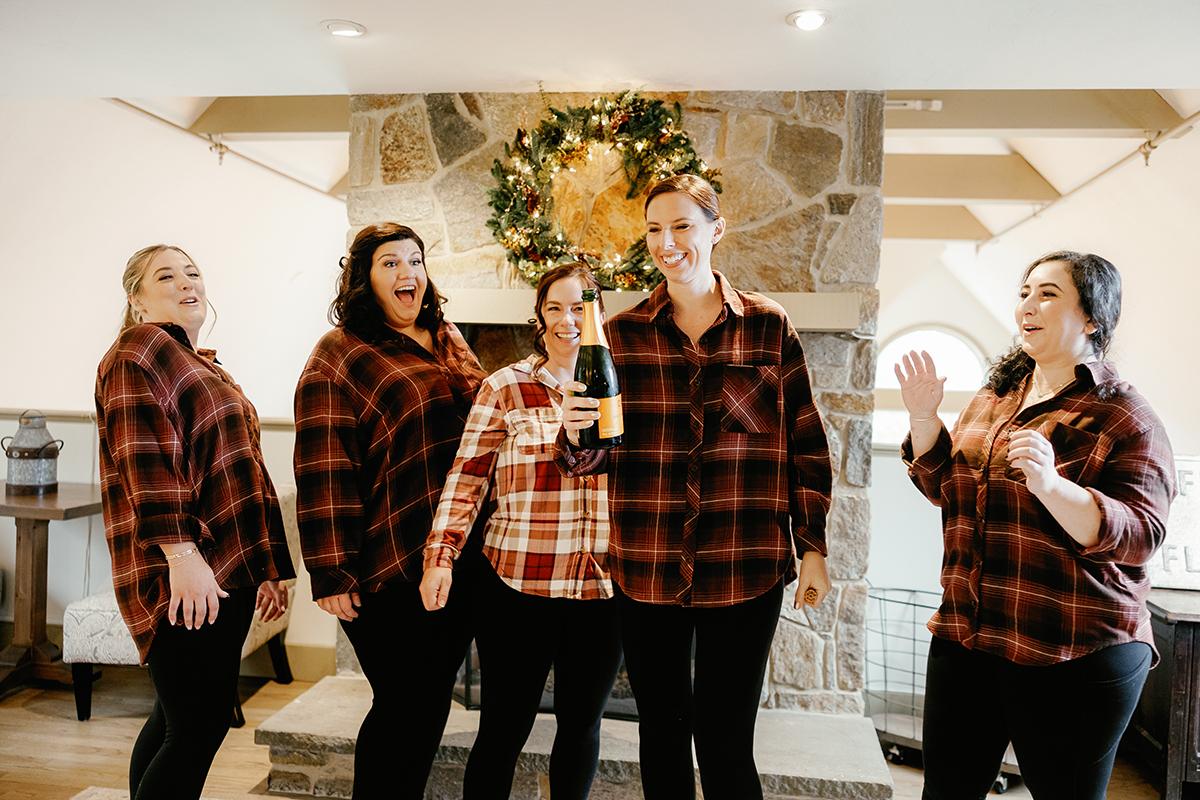 bridesmaids opening champagne