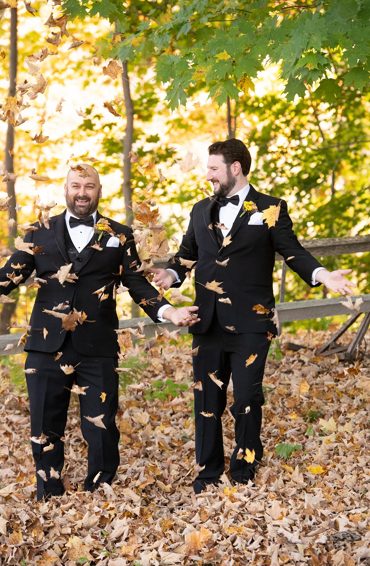 couple playing in leaves