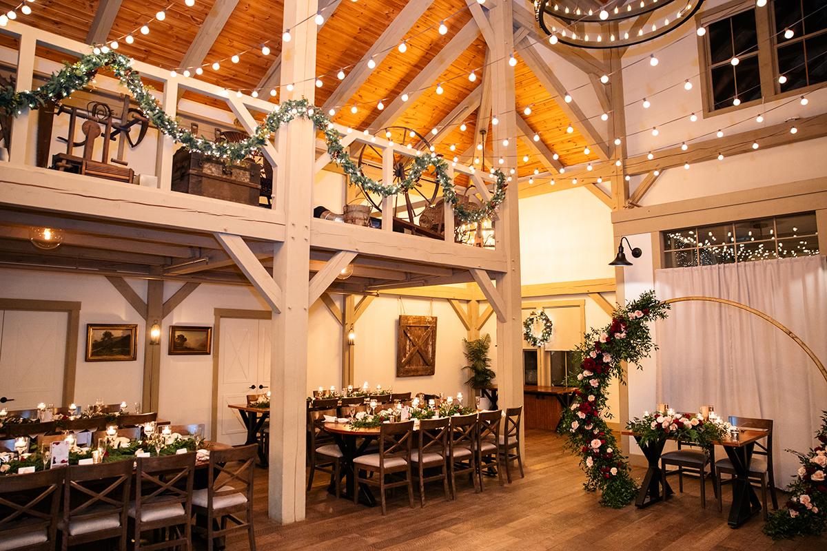 Warm, festive banquet hall with string lights and garlands.