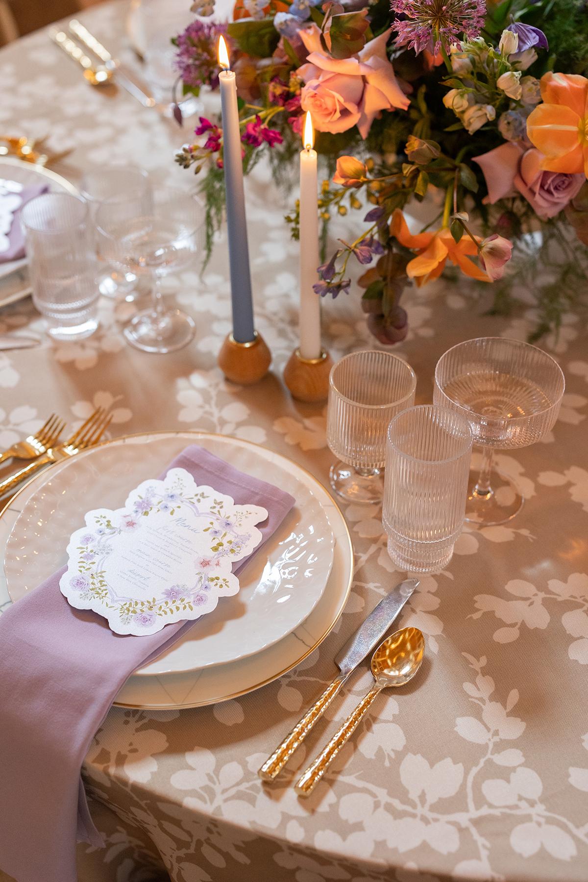 Elegant table setting with floral centerpiece and candles.