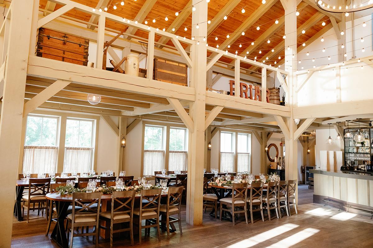 Bright, rustic dining room with wooden beams and string lights.