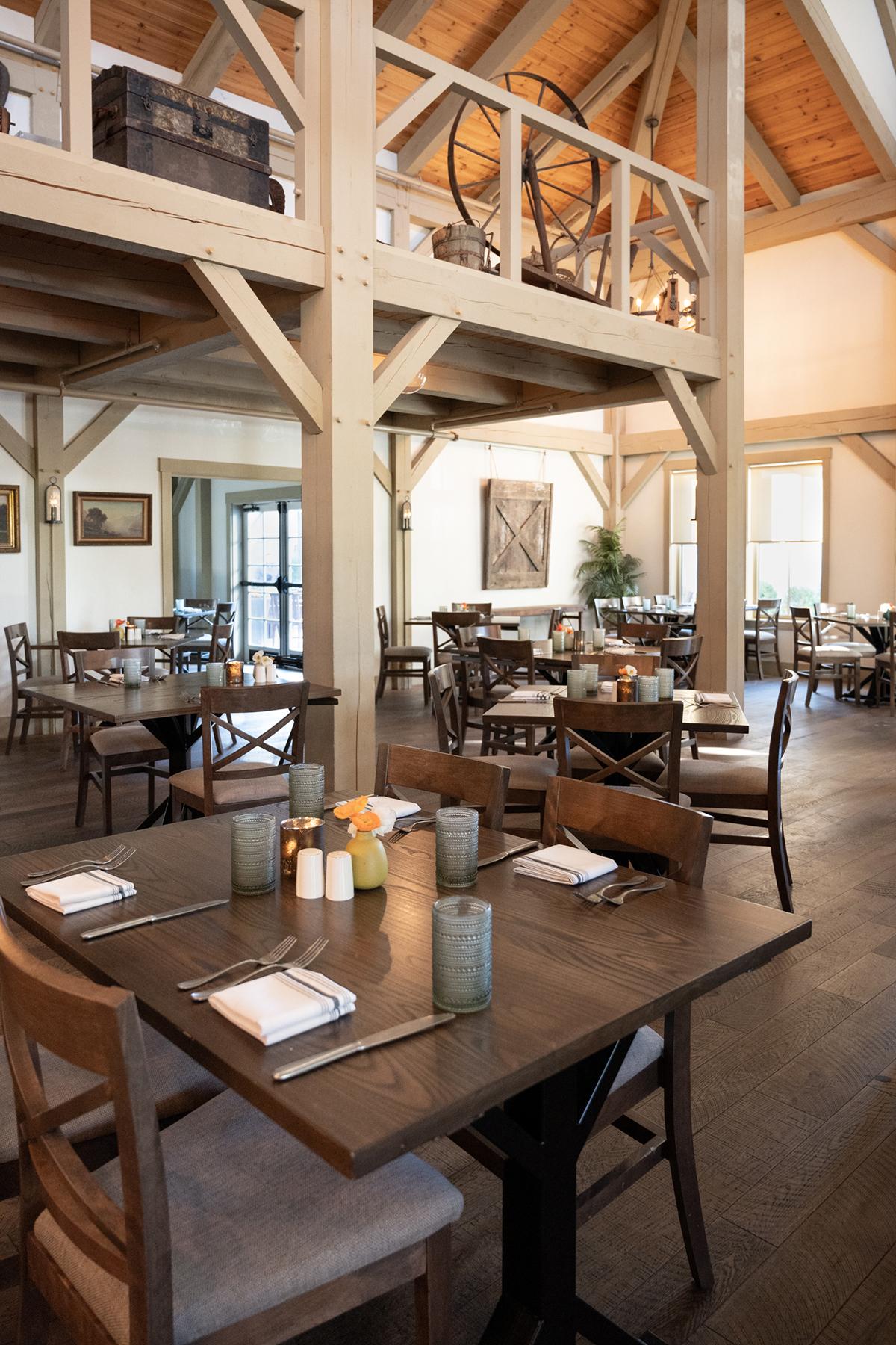 Rustic restaurant dining area with wooden tables and chairs.