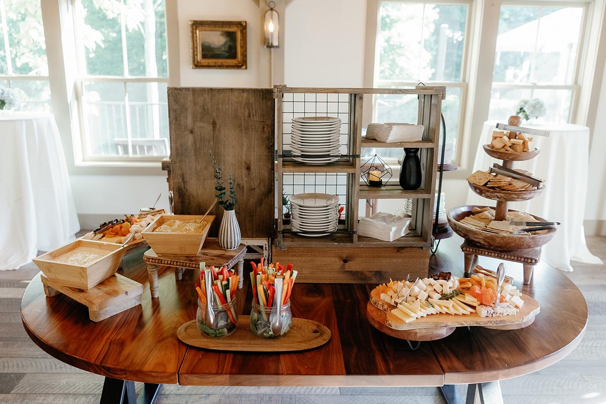 Buffet table with snacks, pastries, and breadsticks in jars.