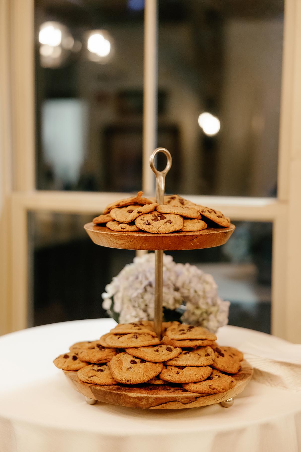 Two-tiered tray with cookies on a table indoors.