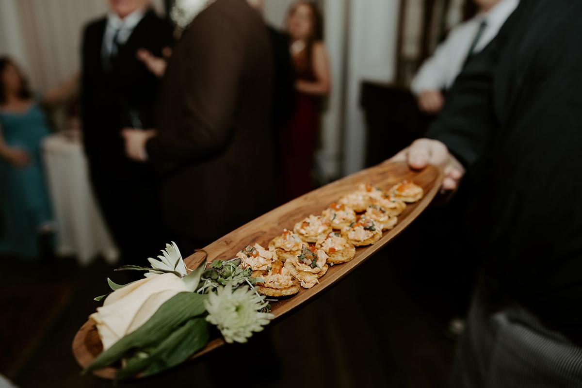 Tray of appetizers held at a social gathering.