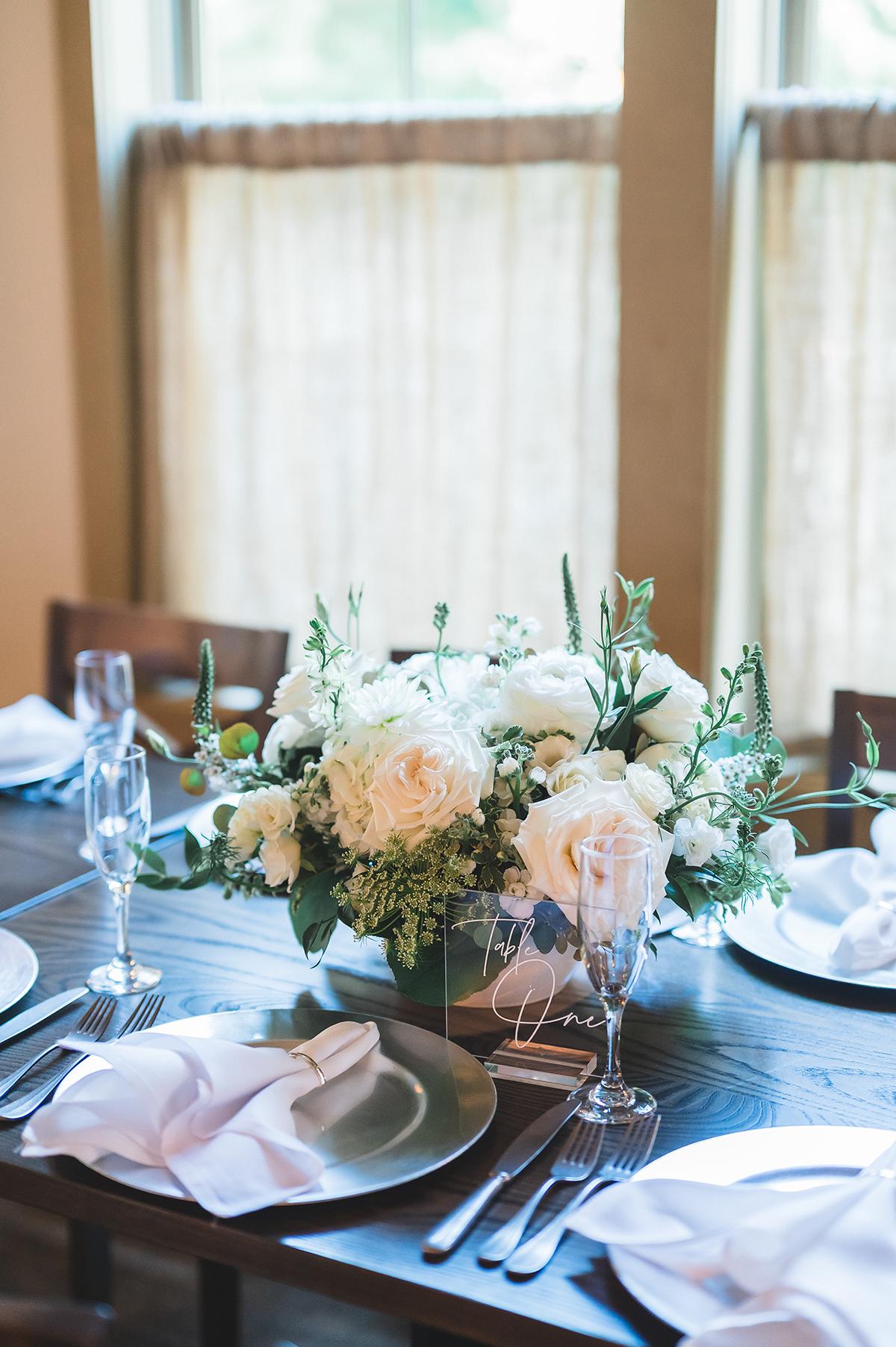 Elegant table setting with floral centerpiece and folded napkins.