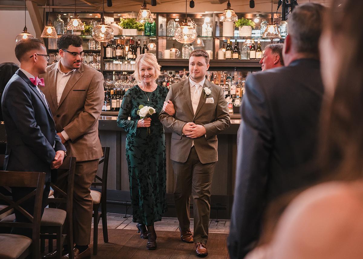 Elegant event in a warmly lit room, people dressed formally.