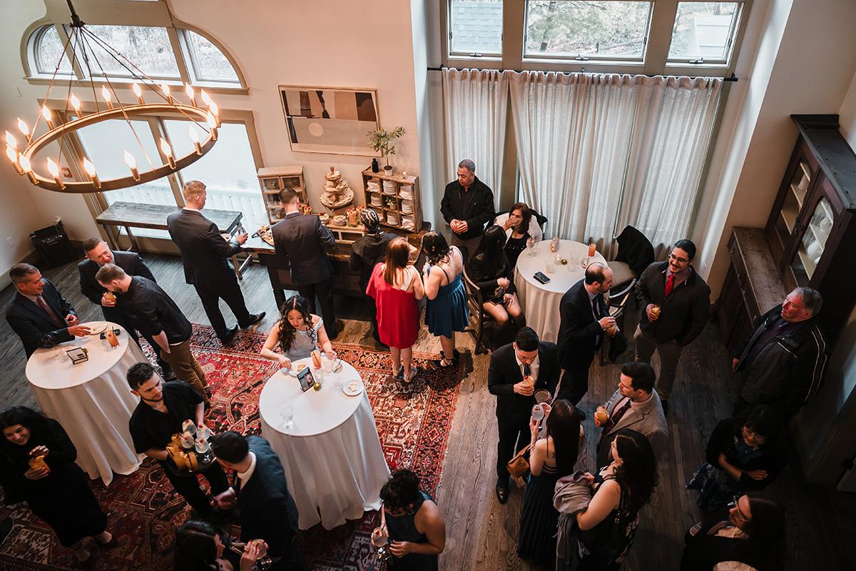 Guests mingling at a formal reception, seen from above.