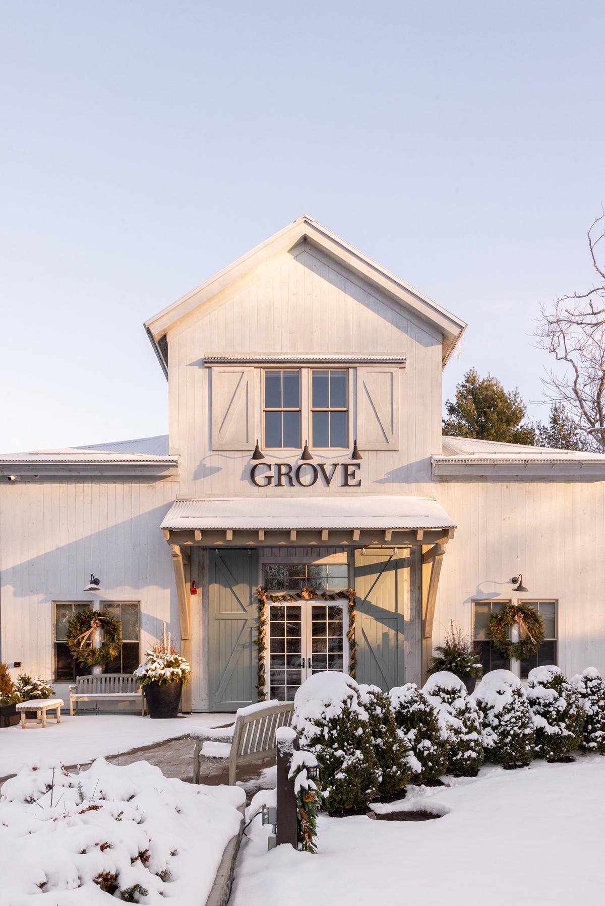 Snow-covered white house with a sign reading “GROVE” above the entrance.